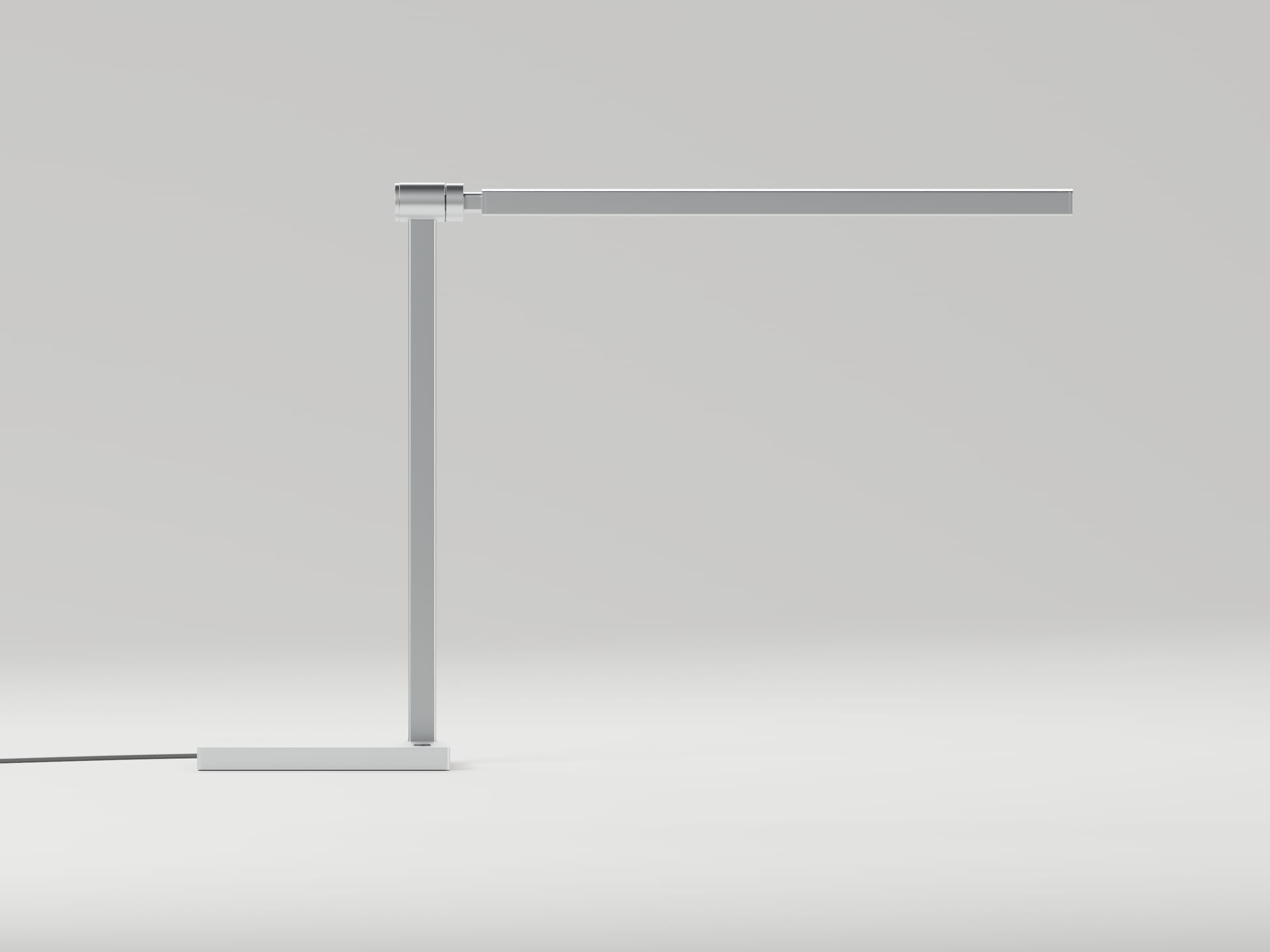 Front elevation of L01: a vertical support and a long horizontal head meeting at a cylindrical hinge, on a thin rectangular base.